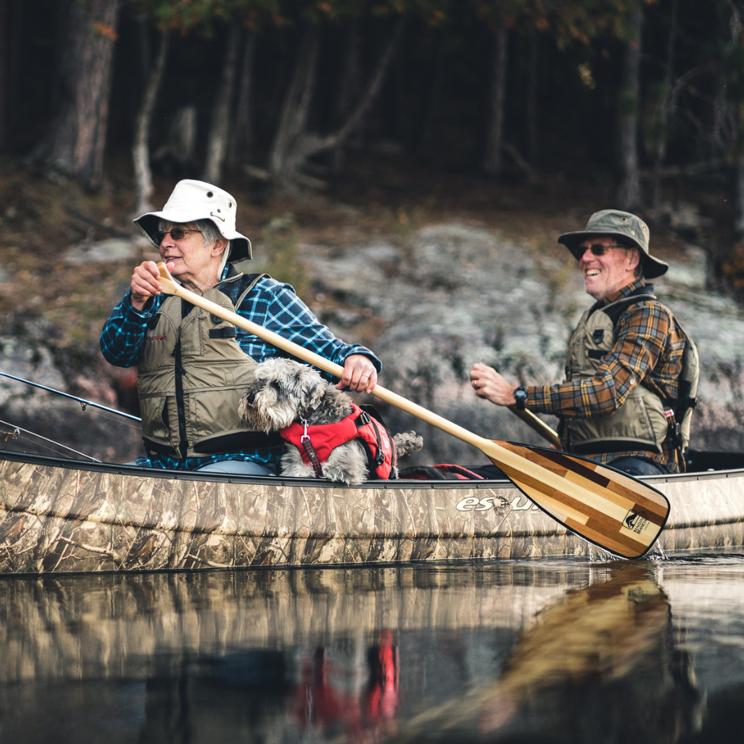 Catalyst ST being paddled by an older woman sitting in the bow. Terrier dog next to her lap.