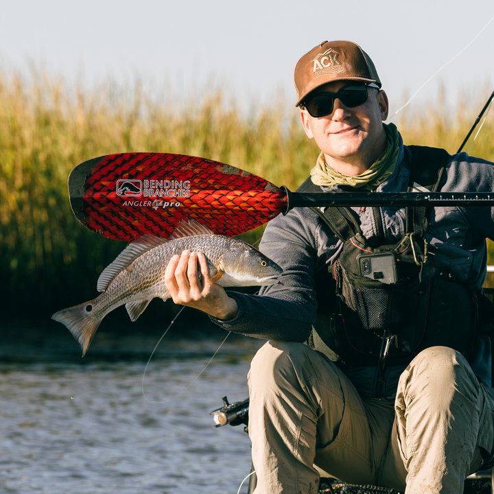 Copperhead kayak fishing paddle next to fish