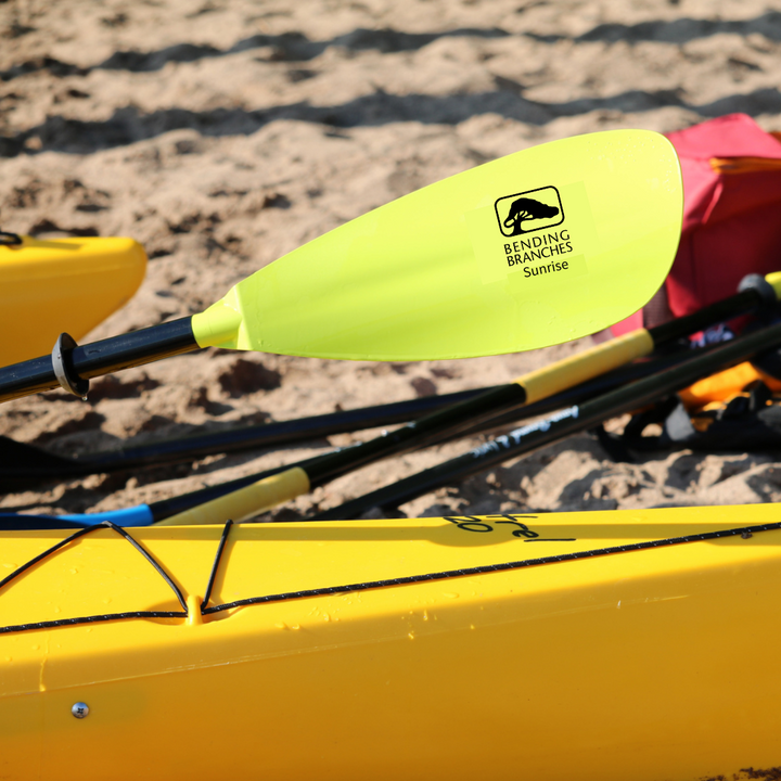 Sunrise Glass Yellow blade leaning across yellow kayak on the beach