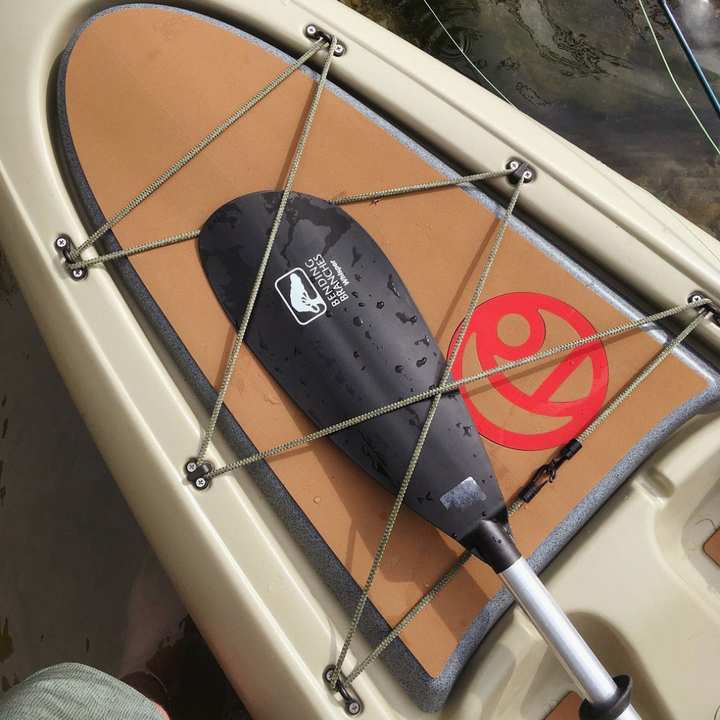 Whisper strapped in a kayak's front bungies