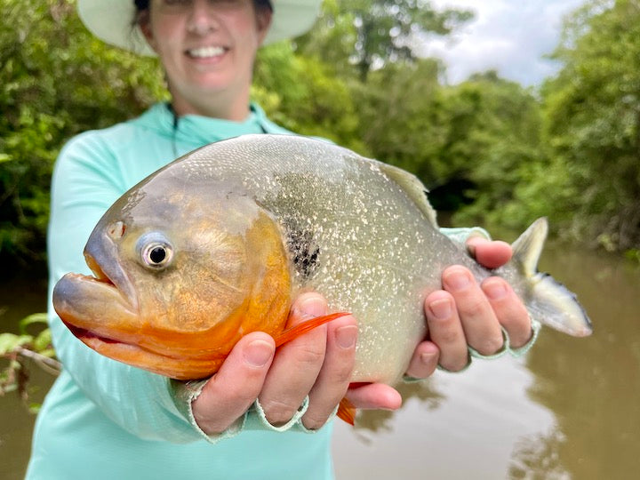 woman holding a red piranha