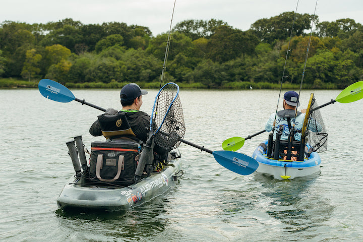two kayak anglers paddling on a small lake