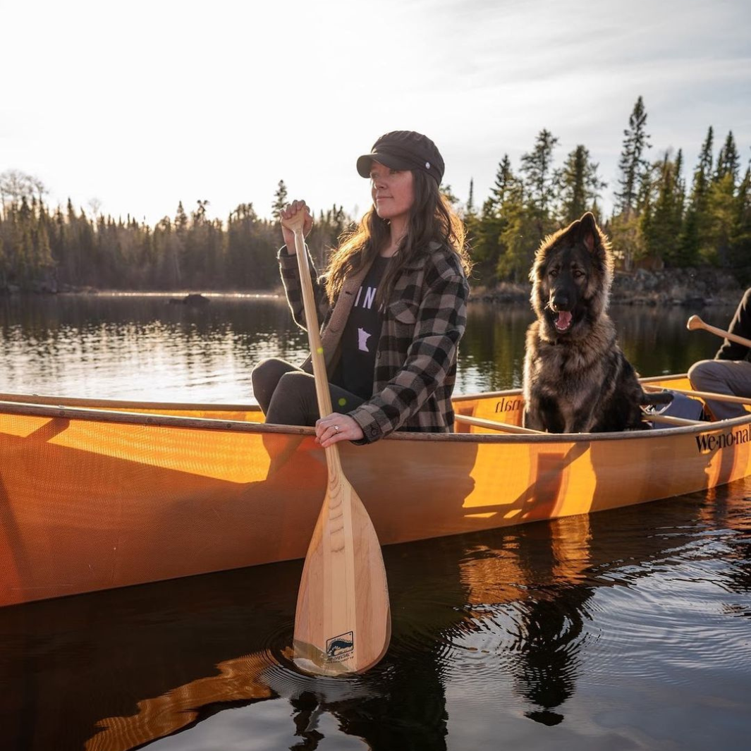 Female paddler paddling from the bow with the BB Special as her wolf-like dog rides in the middle