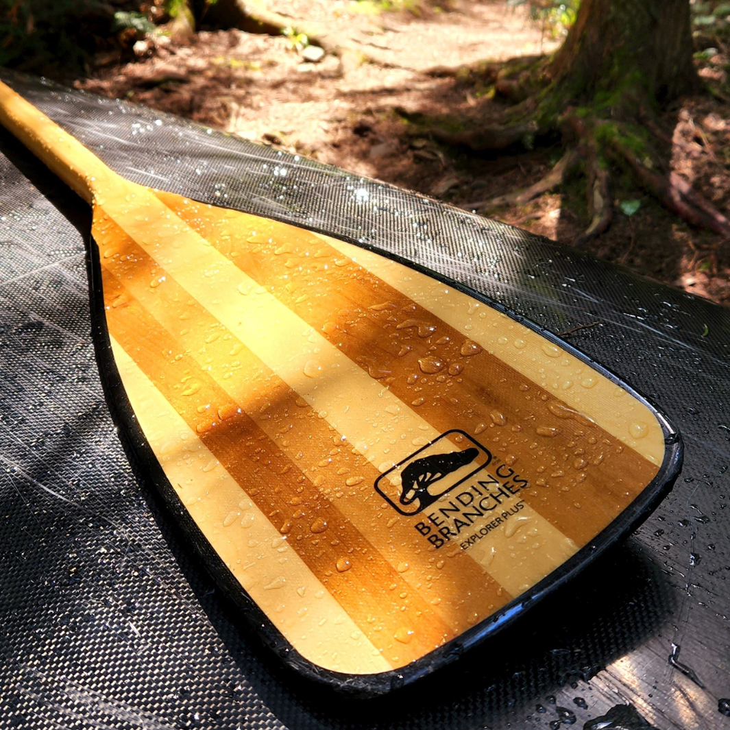 Exploreer Plus Canoe paddle resting atop a canoe after rain