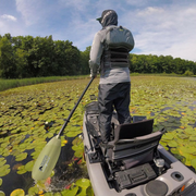 angler classic snap button sage green being paddled through lily pads