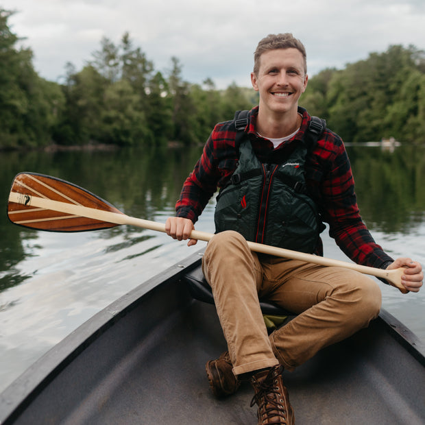 Person holding Java canoe paddle in canoe