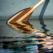 Explorer Plus wooden canoe paddle blade coming out of water