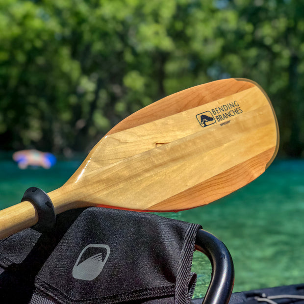 Impression kayak paddle blade resting on kayak seat